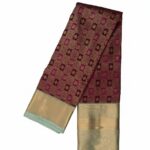 Kanchipuram Tissue Silk Saree rich maroon or wine-colored body with a contrasting bluish-green border and pallu.