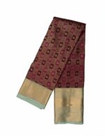 Kanchipuram Tissue Silk Saree rich maroon or wine-colored body with a contrasting bluish-green border and pallu.